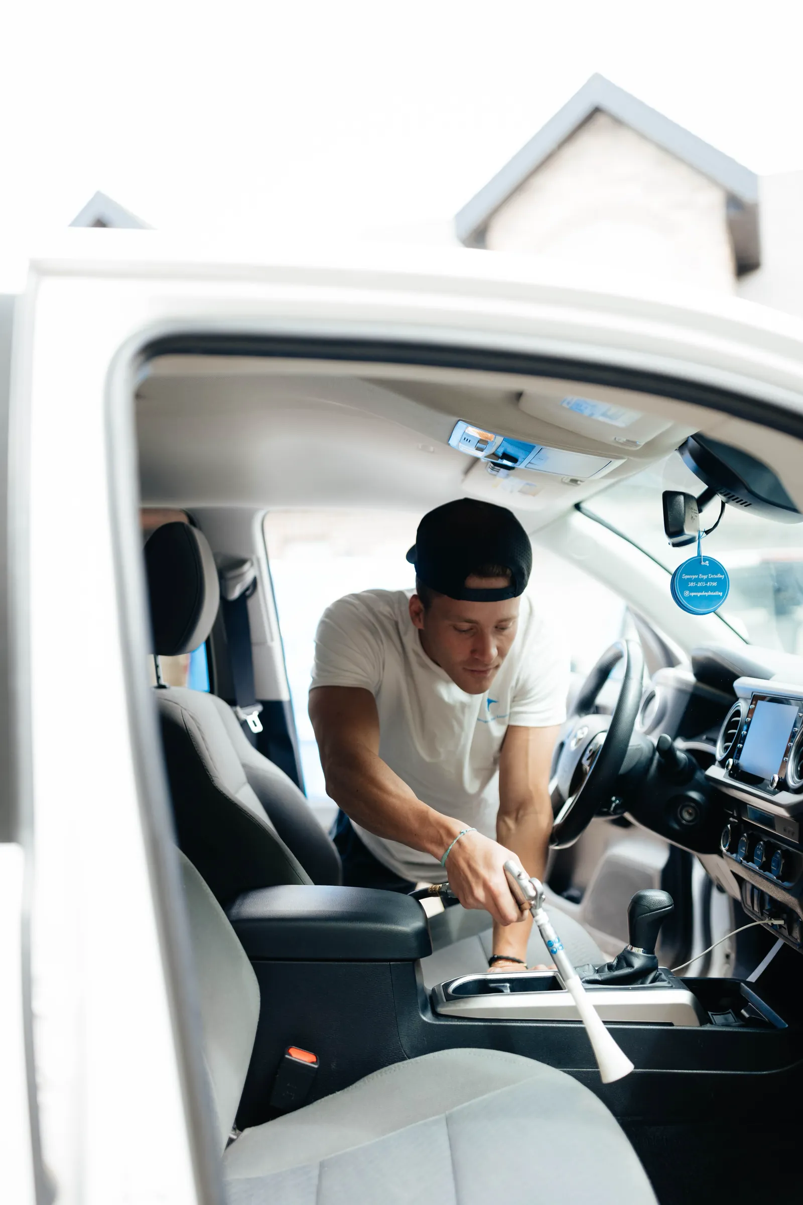 Skylo technician cleaning a vehicle center console