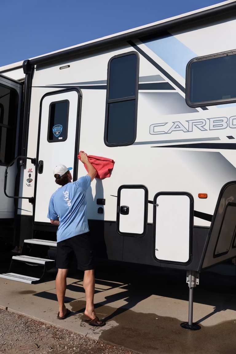 Skylo technician wiping down an RV exterior